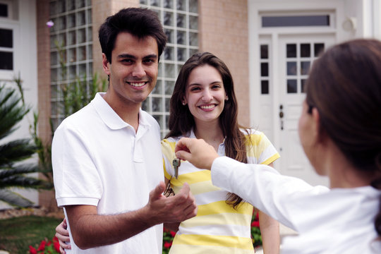 Real estate agent handing over house key