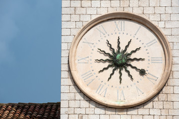 Fototapeta na wymiar Sun clock face on the old clock tower, Dubrovnik, Croatia