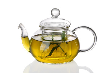 Teapot with tea and fresh leaves