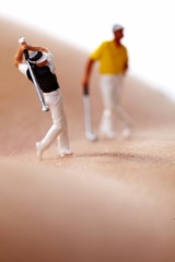 Obraz na płótnie Canvas Miniature Figures playing golf on naked woman body