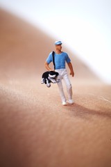 Miniature Figures playing golf on naked woman body