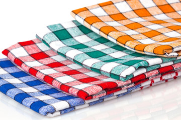 Obraz premium Four colored kitchen towels isolated