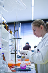 portrait of a female researcher doing research in a lab (color t