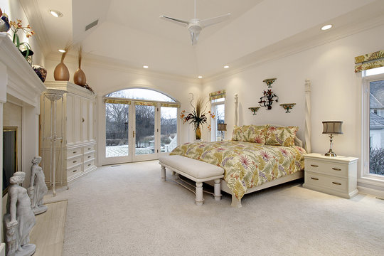 Master bedroom with white fireplace