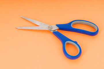 Colorful scissors on the color paper background