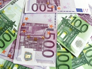 Background of scattered 100 and 500 euro banknotes, close-up