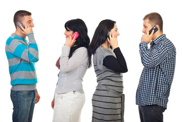 Obraz premium Couples talking by phone mobiles