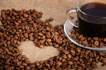 cup of coffee on the canvas with coffee beans