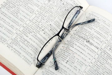 Eyeglasses and dictionary