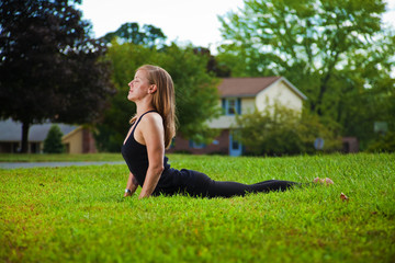 Young girl doing yoga exercise alone