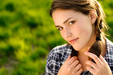 Pretty girl with pigtails relaxing outdoors