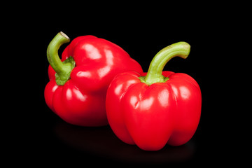 Red peppers isolated on black