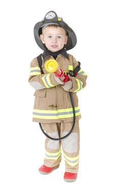 Toddler dressed as fireman ready to put out a fire
