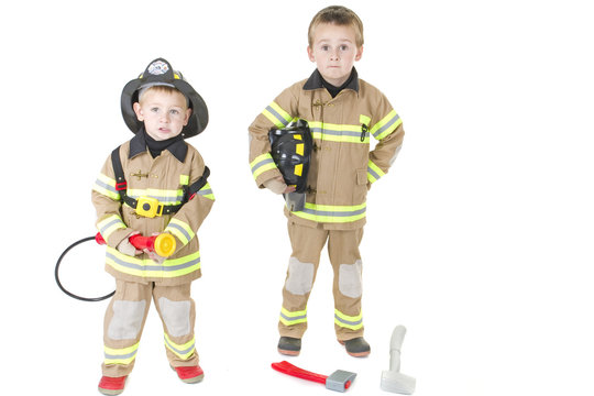 Two children dressed as firemen ready for duty
