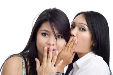 woman telling her friend a secret