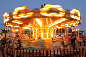 Motion blurred carousel at night.