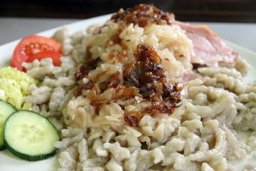 Cheese spaetzle home-made noodles with smoked jam and sweet onio