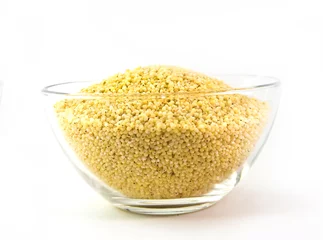 Fototapeten millet grains in bowl isolated © ievavincer2
