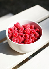 Bowl of Raspberries outside in summer