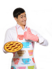 Young man in apron baked tasty pie. isolated on white background