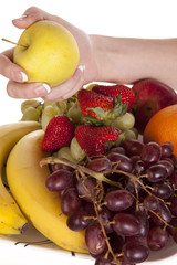 Grabbing apple from fruit plate