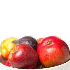 White bowl with fruit on white background