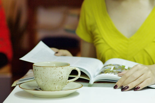 a cup of coffee and magazine
