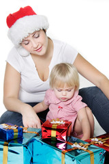 mother and daughter with christmas gift boxes over white