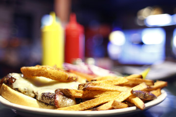 Open faced cheeseburger and french fries