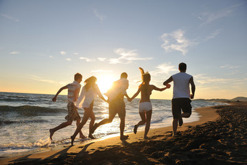 Fototapeta premium people group running on the beach