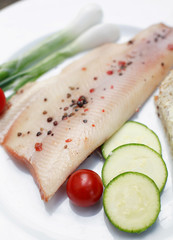 Fresh peppered trout with vegetables and salad