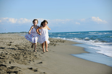 Fototapeta na wymiar cute little girls running on beach