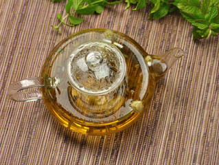 glass teapot with hot green tea