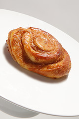 Cinnamon roll on white plate
