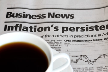 An cup of coffee on a business newspaper
