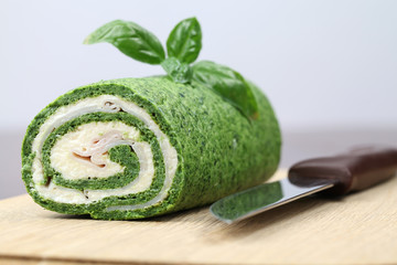 Spinach roll with garlic cheese and ham. Shallow dof