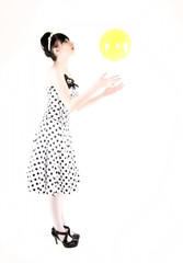 Portrait of a young girl posing with yellow ball