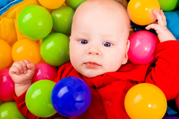 Fototapeta na wymiar Infant with colorful balls
