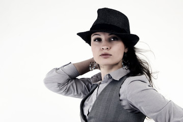 Portrait of a young fashionable brunette in hat