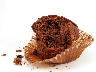 Chocolate muffin - half eaten on paper