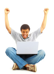 Happy young man working on a laptop,