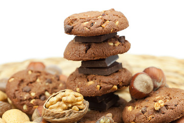 oatmeal cookies, chocolate and nuts on a wicker mat