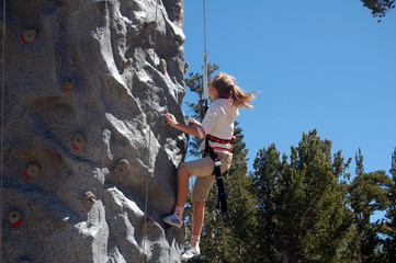 girl climbing wall