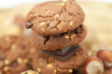 oatmeal cookies, chocolate and nuts on a wicker mat