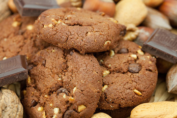 oatmeal cookies, chocolate and nuts on a wicker mat