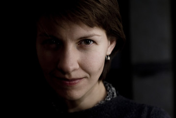 young woman's face half shadowed