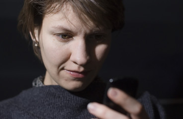 young woman watches her phone