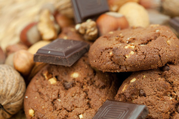 oatmeal cookies, chocolate and nuts on a wicker mat