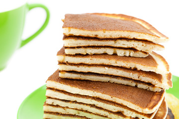 Pancakes on a plate and cup isolated on white