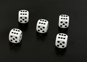 Dices with sixes on black background